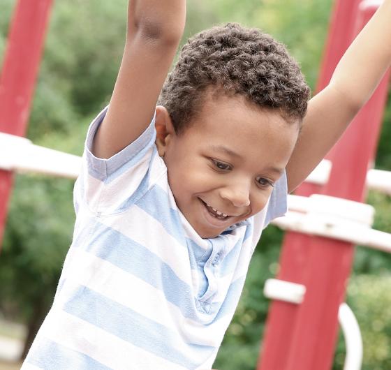 Boy plays on monkey bars
